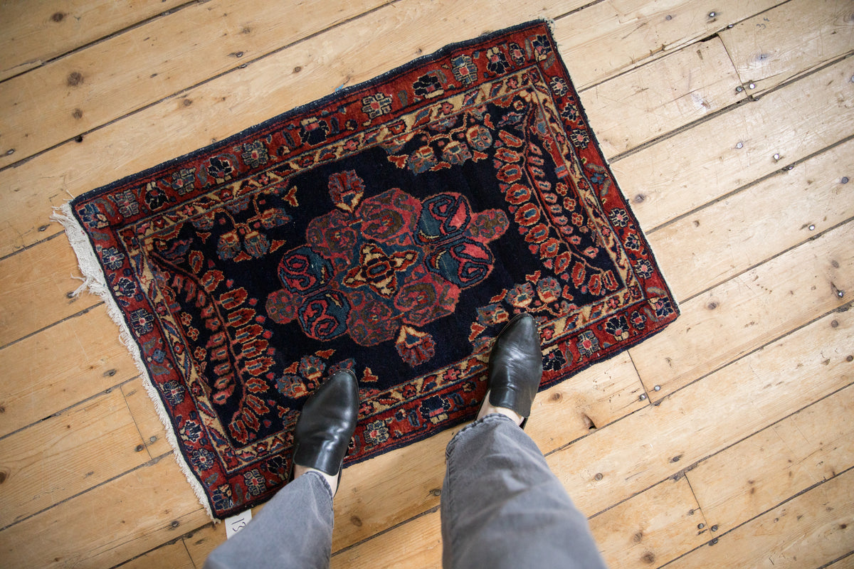 Antique Mohajeran Sarouk rug, dark navy field with transitional scrolling arabesque medallion.