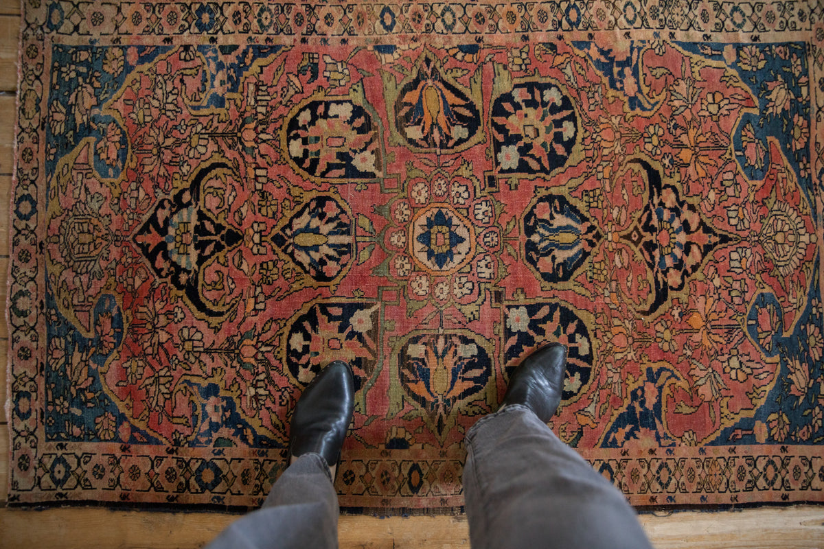 Antique Farahan Sarouk rug corner, highlighting blush field with navy spandrel floral motifs.