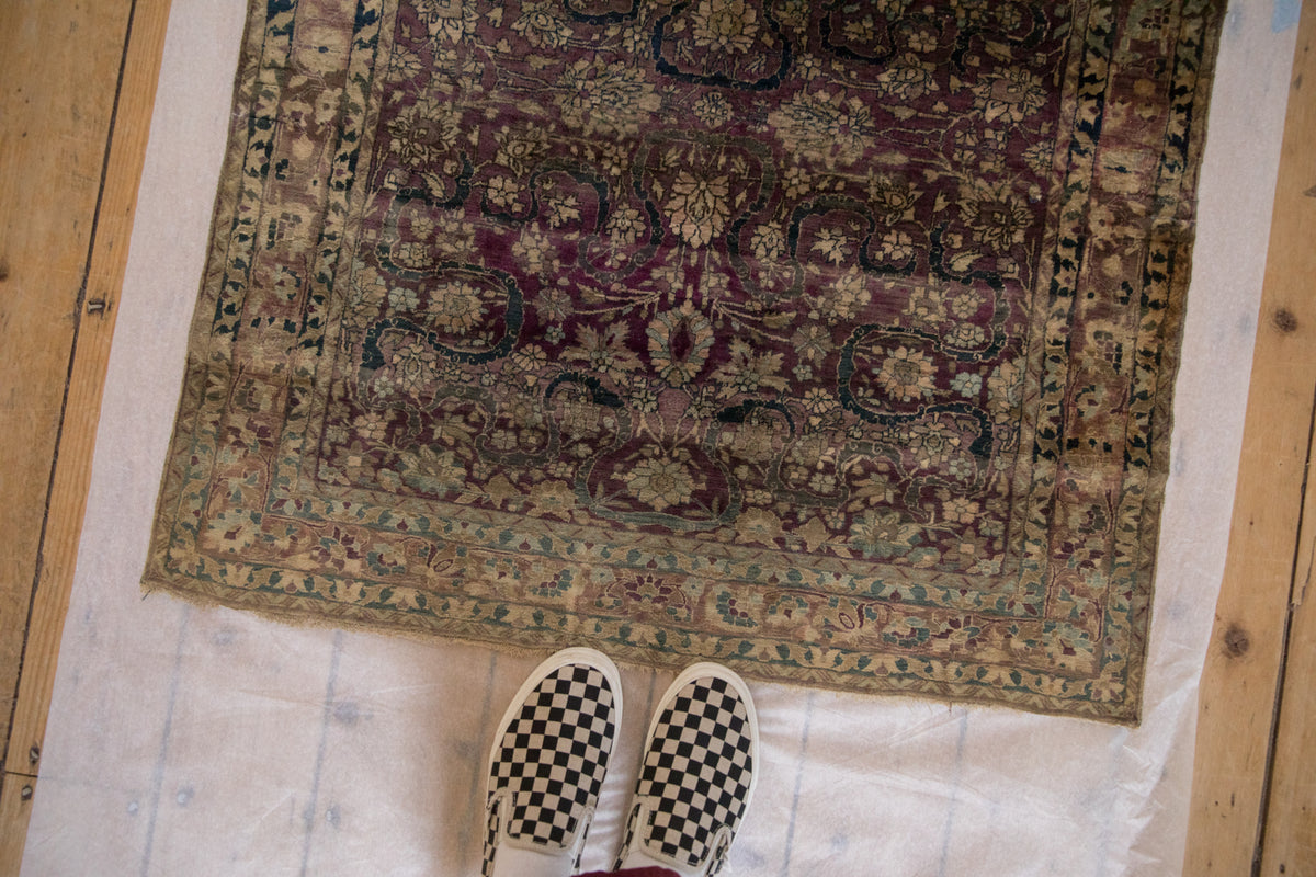 Antique Mohtashem Kashan's all-over floral pattern: palmettes, arabesques, aubergine, and powder blue.