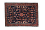 Antique Mohajeran Sarouk rug, navy field with delicate floral vines, central roundel, raspberry border.