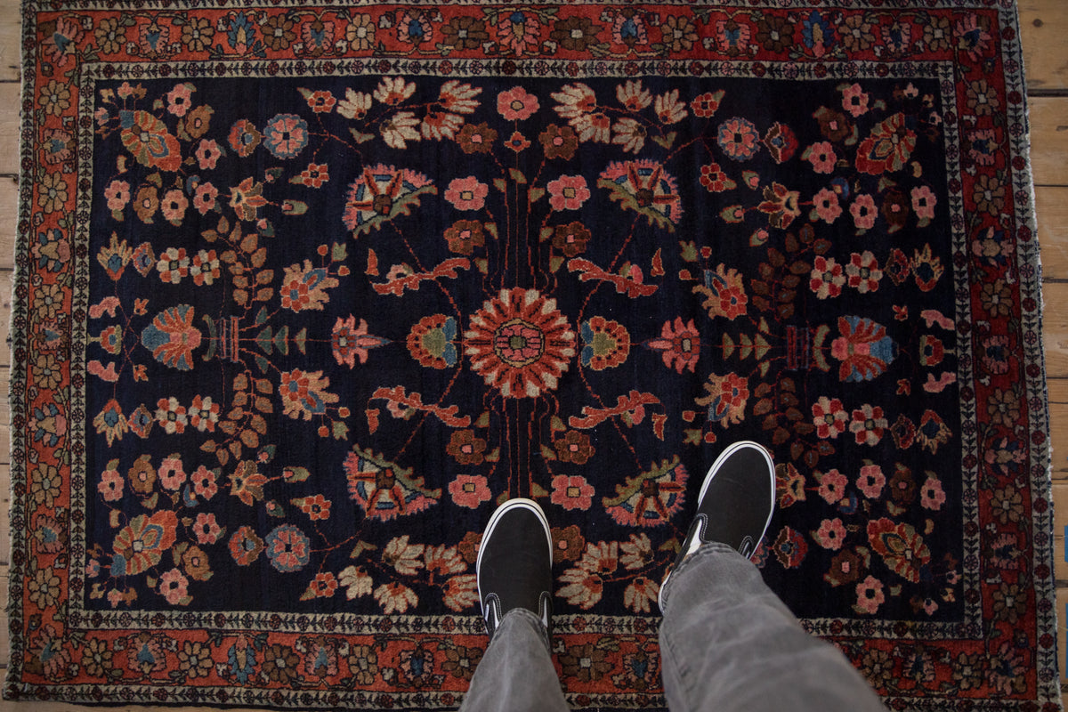 Antique Mohajeran Sarouk rug, navy blue floral field, central roundel, raspberry border. 3'5" x 4'10".
