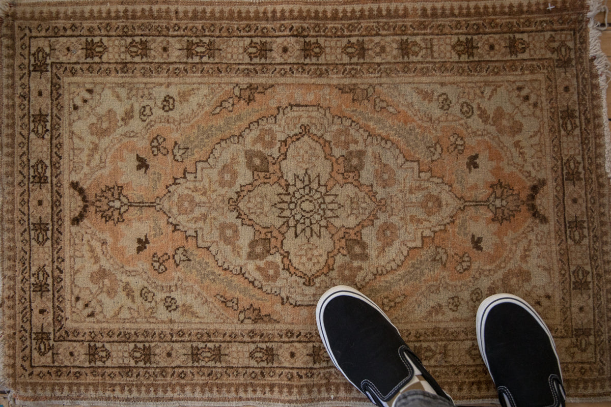 Antique Tabriz rug featuring starburst medallion, cypress ferns, and pawn motif borders in muted earth tones. 2x3.