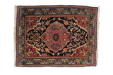 Antique Persian Farahan Sarouk rug featuring a cochineal red scalloped medallion on a navy field with floral vines and a teal border, early 20th century.