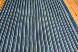 Hand-woven indigo blue striped textile, showing natural variations and collectible vintage character.
