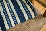 Vintage African cotton throw with nuanced indigo blue stripes and hand-stitched edge.