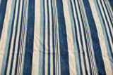 Vintage African hand-woven textile featuring varied indigo blue and natural striped pattern.