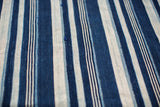 Hand-woven indigo blue and off-white striped textile showcasing vintage texture.