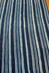 Indigo blue striped pattern with varied tones on a hand-woven vintage African textile.