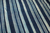 Handwoven vintage indigo striped textile in time-softened blues with a rich texture.