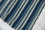 Detail of the richly textured indigo and cream striped vintage African textile.