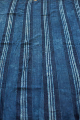 Collectible vintage indigo blue textile with hand-woven varied striped patterns.