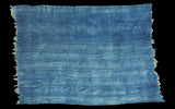 Handwoven vintage indigo cotton throw with horizontal seams and natural frayed edge.