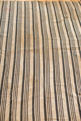 Close-up of hand-woven indigo striped textile, showcasing vintage character and texture.