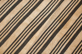Vintage hand woven indigo textile featuring dark diagonal stripes and natural cotton texture.
