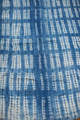 Detailed view of the hand-woven indigo batik textile with unique white resist patterns.