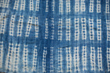 Close-up of handwoven vintage African indigo textile featuring unique resist-dye patterns.