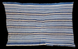 Vintage indigo textile, hand woven with varied blue and natural cream striped pattern.