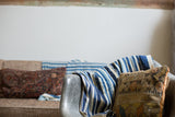 Collectible vintage African indigo throw, hand woven with varied blue and natural white stripes.