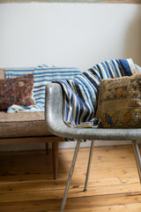 Supple hand-woven vintage indigo throw with varying blue and cream stripes.