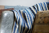 Vintage Indigo Stripe Throw showing its hand woven texture and varied blue and cream stripes.