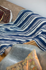 Vintage African indigo throw with hand-dyed blue and cream stripe pattern.