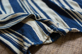 Textural hand-woven indigo and off-white stripes on a vintage cotton throw.