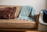 Light blue Vintage Denim Batik Throw with subtle woven texture and fringed edge.