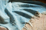 Vintage African indigo throw with hand-woven texture and naturally frayed edges.