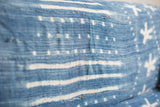 Collectible indigo textile showing hand-dyed blue, white stripe patterns, and cotton weave.