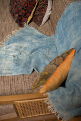 Textured blue hand-dyed indigo throw with stitched detailing and natural fringed edge.