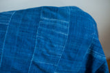 Close-up of Vintage Indigo Throw, hand-dyed blue cotton with subtle striations.