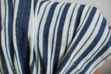 Hand-woven cotton texture of vintage indigo stripe throw, showing nuanced blue and off-white bands.