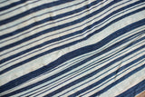 Textured hand-woven vintage indigo throw detail with rich blue and faded stripe variations.