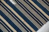Collectible African indigo textile showcasing hand woven blue and light striped cotton with vintage character.
