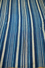 Vintage hand-woven indigo blue striped textile, with varied shades and subtle texture.