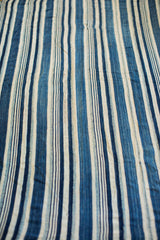Nuanced hand-dyed indigo and cream striped pattern on vintage African textile.