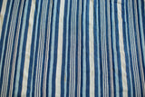 Textural view of hand-dyed indigo blue and cream stripes on vintage African textile.