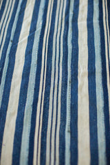 Textured vintage indigo cloth with hand-dyed blue and natural off-white stripes.