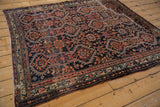 Angled view of the energized, allover geometric pattern on an antique Persian Malayer rug.