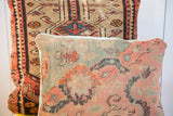 Pink and blue curvilinear pattern on an antique Turkish rug fragment pillow, light blue piping.