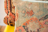 Textured weave of an antique Turkish rug fragment pillow, muted blue, pink, and terracotta.