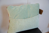 Pillow back with light blue corduroy fabric, detailed envelope closure, and brown tag.