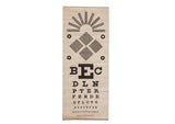 Antique eye chart with black geometric shapes and alphabet letter rows on aged paper.