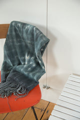 Long grey-blue tassels and hand-dyed blue-green pattern of a vintage African textile.