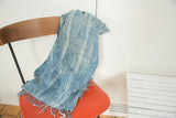 Hand-woven denim blue and ivory African indigo textile with short fringes.