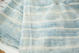 Visible texture of hand-woven vintage African textile, featuring ivory and powder blue stripes.