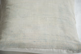Woven texture of a faded powder blue African indigo pillow with subtle horizontal stitching.