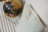 Faded powder blue vintage indigo pillow texture and hand stitching.