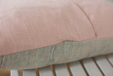 Faded pink European linen joining textured powder blue African indigo pillow fabric.