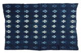 Collectible vintage African indigo throw, hand woven with blue and ivory fish motifs.